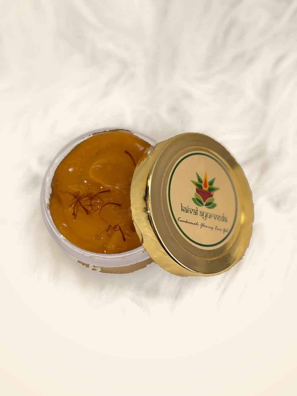 Kaival Ayurveda Kumkumadi Glowing Face Gel open jar with saffron strands in golden gel
