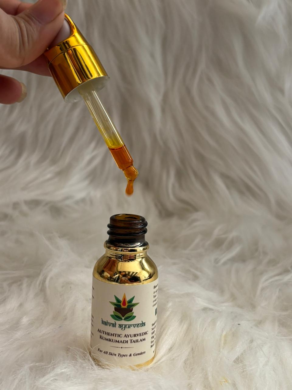 Kumkumadi Tailam golden oil dropper with oil drop